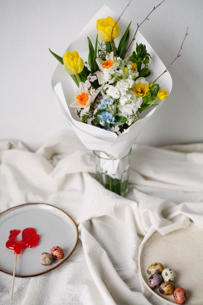 Offerings A vibrant spring bouquet with yellow tulips and colorful flowers, perfect for Easter celebrations.