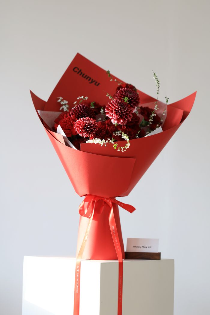 Offerings Stylish red bouquet of chrysanthemums in vibrant red wrapping, ideal for special occasions.